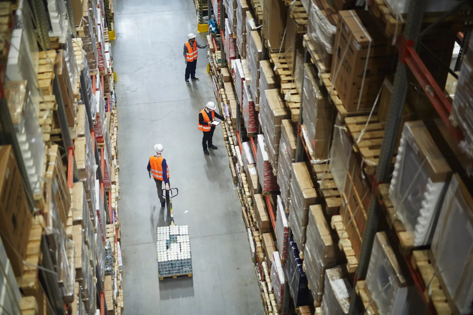 Warehouse operations team reviewing catalog data on the floor