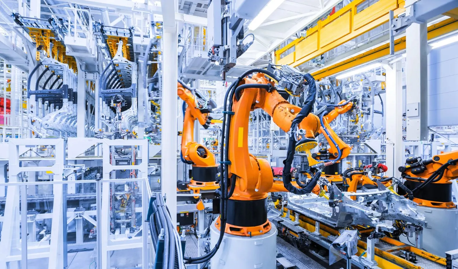 Robotic arms welding on an automated automotive assembly line